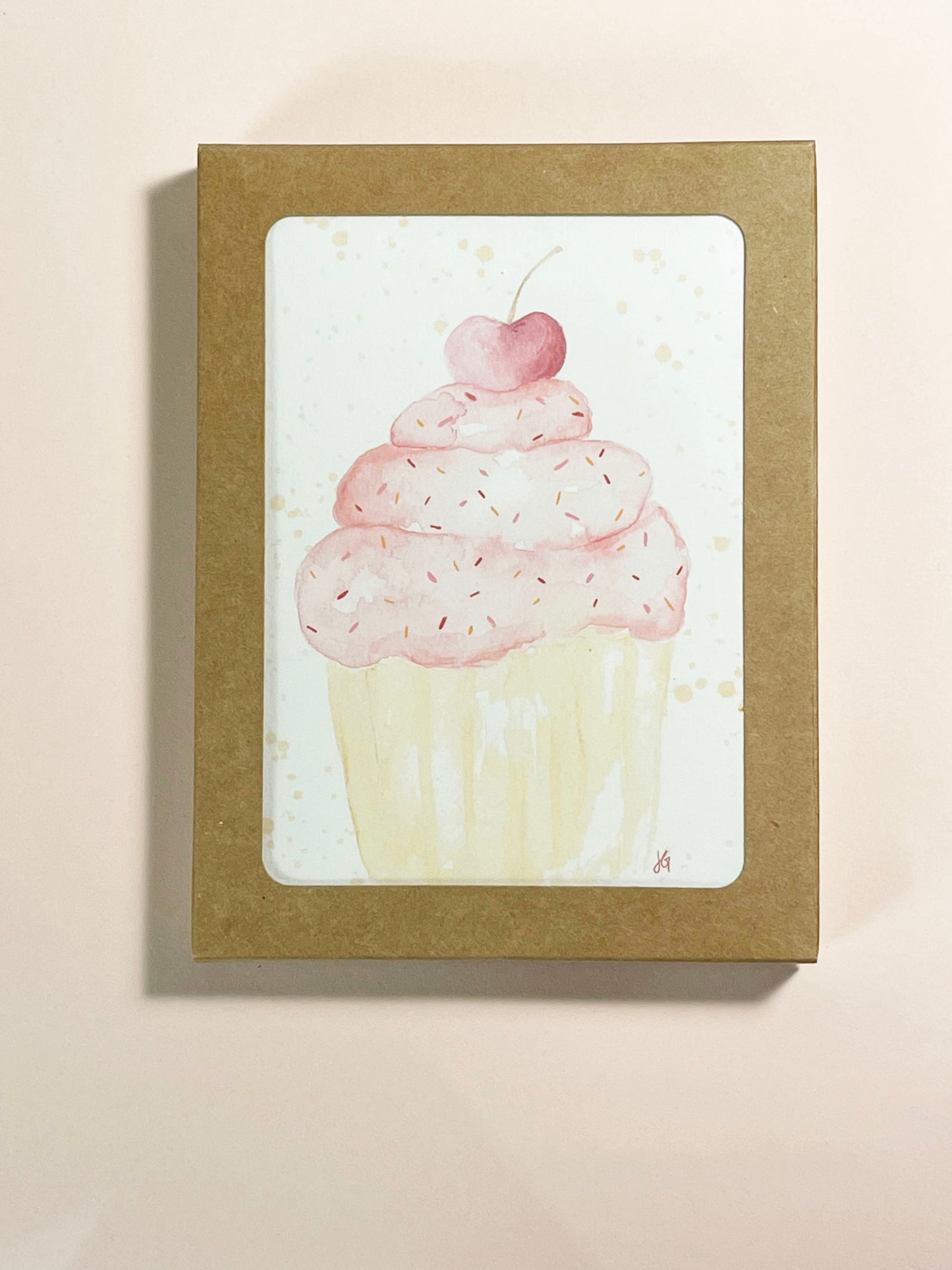 pink cupcake with a cherry on top, varying shades of pink and orange sprinkles, watercolor illustration greeting card, blank inside. This is a boxed set a cards, 6 cards and 6 envelopes come to an order when its boxed.