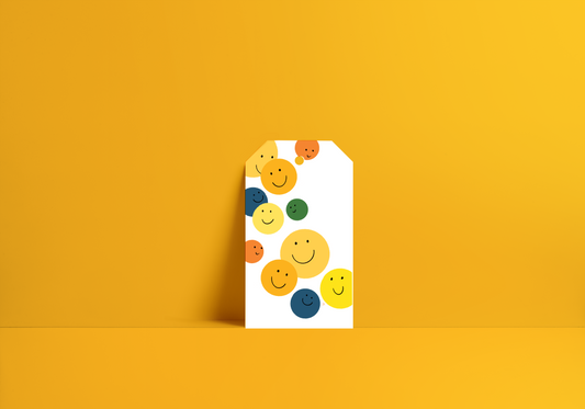 yellow, green, blue and orange smile faces on a gift tag