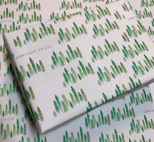 merry happy joy love words on wrapping paper that includes watercolor green trees