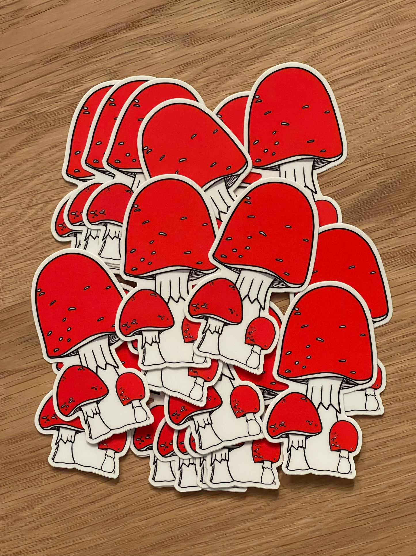 a pile of red mushroom stickers