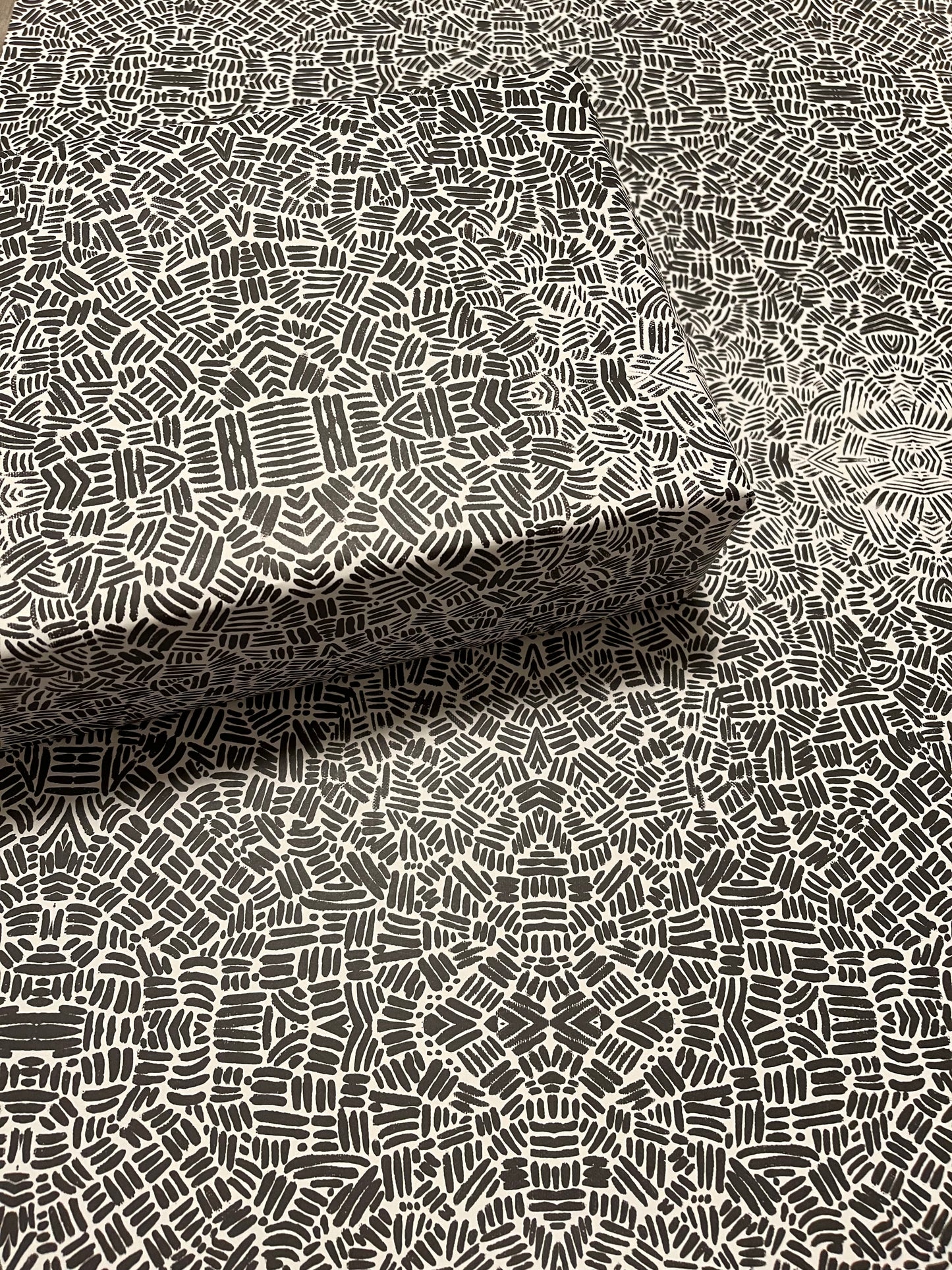 wrapping paper with black and white lines in various angles providing an optical illusion