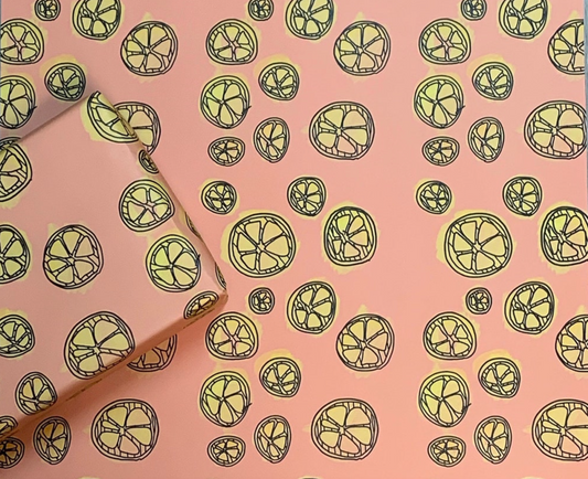 wrapping paper with yellow lemons illustrated on a coral color background