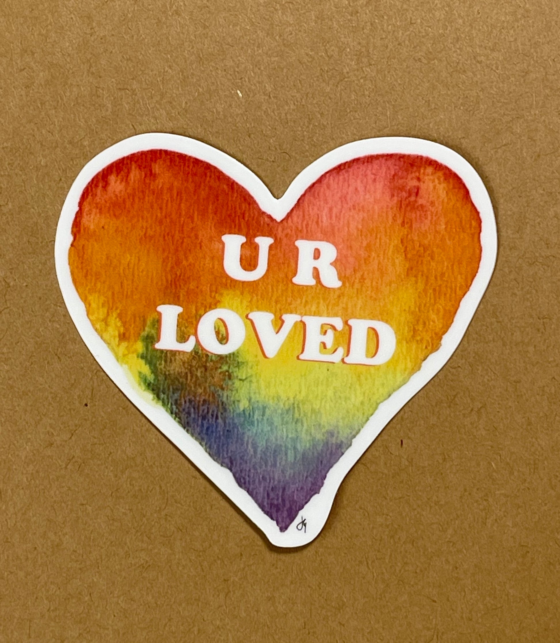 heart shaped sticker, rainbow colored and U R Loved written in the center