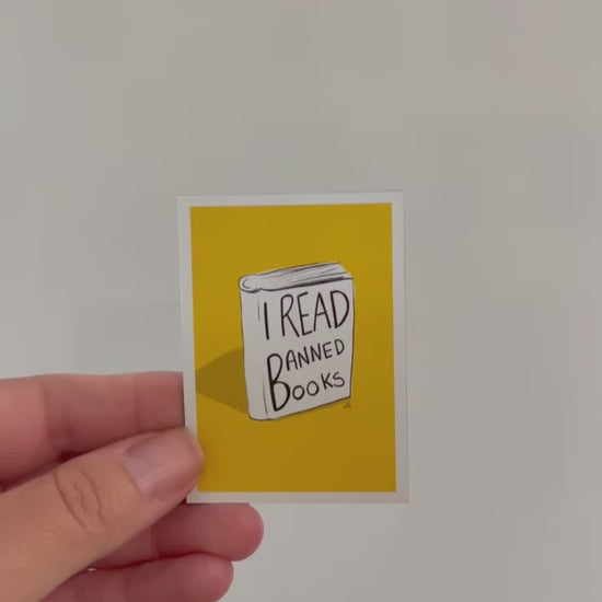 A magnet that has, I read banned books written on a illustrated book with a yellow background video