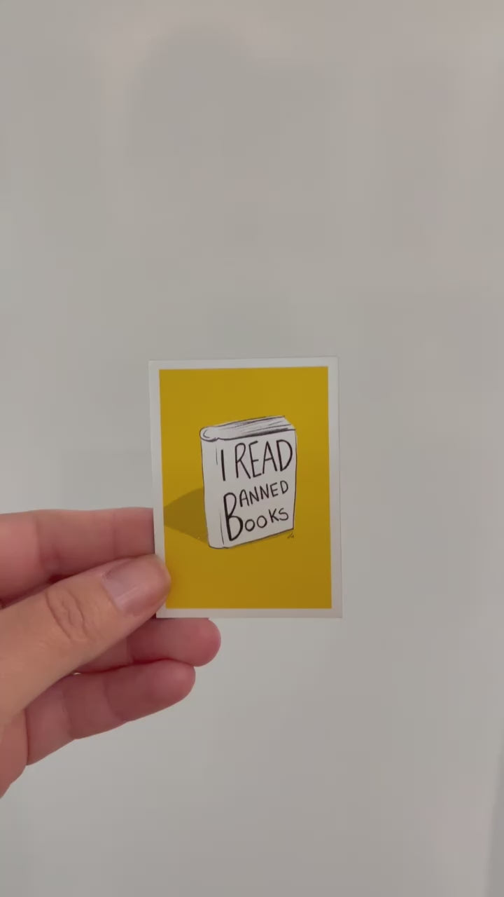 A magnet that has, I read banned books written on a illustrated book with a yellow background video