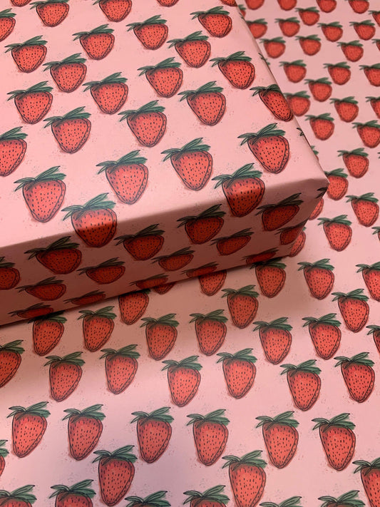 wrapping paper with a repeated strawberry pattern