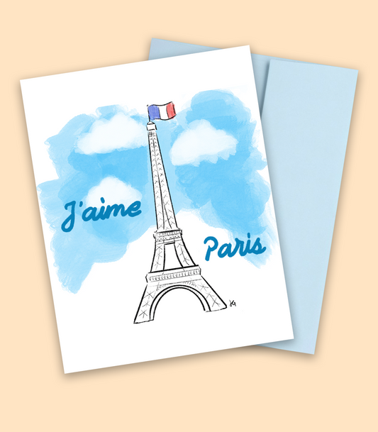 I love Paris written in french with blue clouds in the background and the Eiffel tower displaying the french flag on top