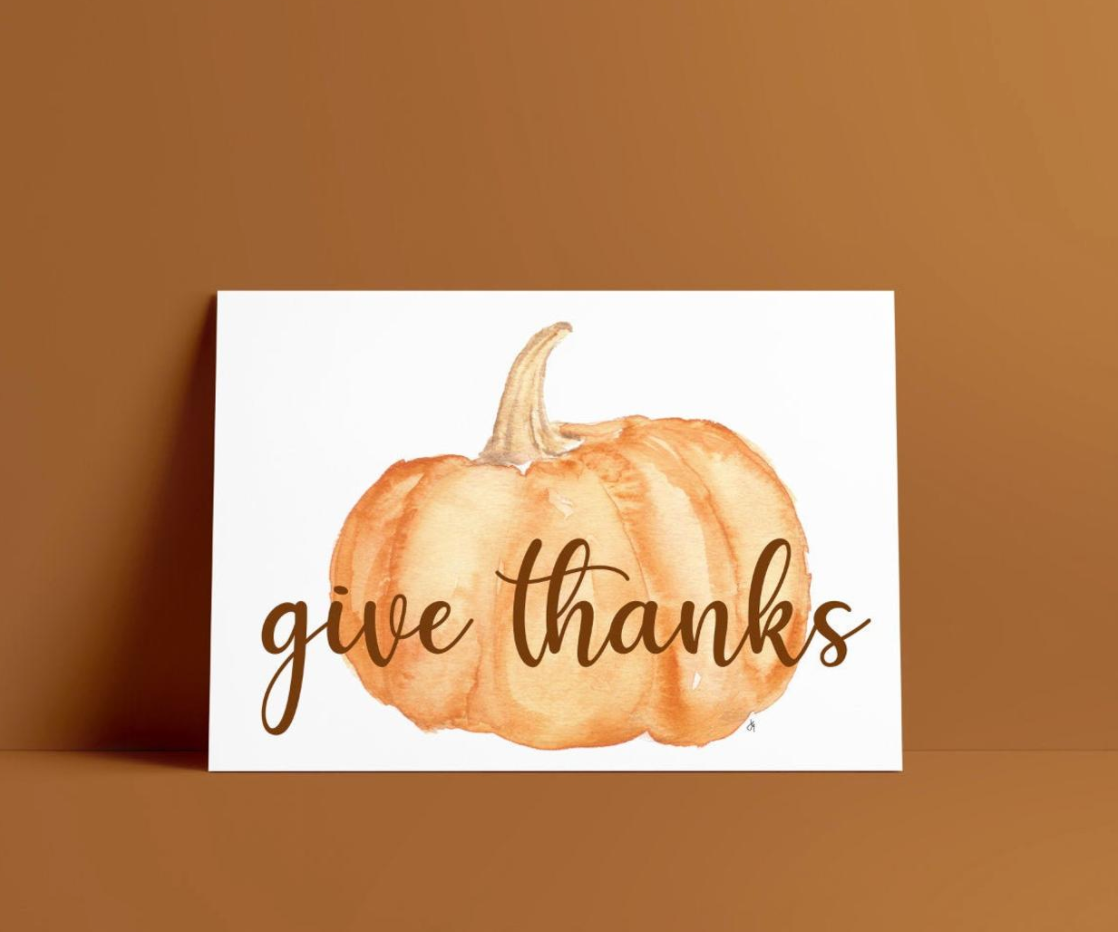 greeting card with a watercolor pumpkin written Give thanks across the front. Blank inside